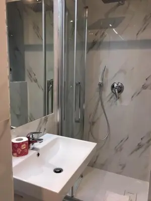 a white bathroom with a sink and a shower at Affreschi a San Pietro in Rome