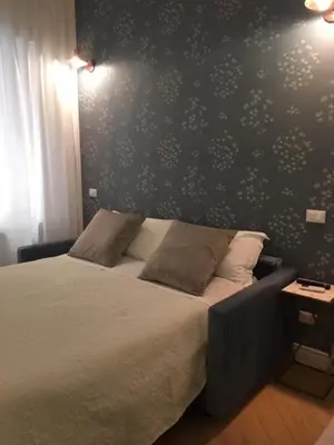 a bedroom with a bed with a black and white wall at Affreschi a San Pietro in Rome
