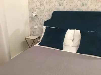 a bedroom with a bed with blue and white pillows at Affreschi a San Pietro in Rome