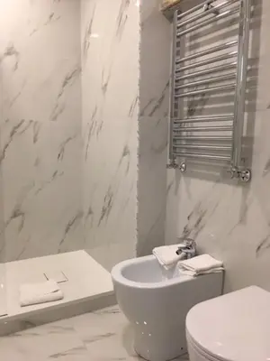 a white bathroom with a toilet and a sink at Affreschi a San Pietro in Rome