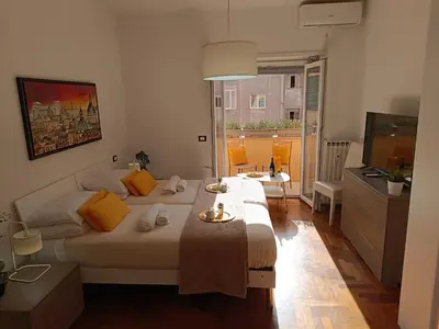 a bedroom with two beds and a television in it at Casa Vacanze Mafalda - Roma Stazione Trastevere in Rome