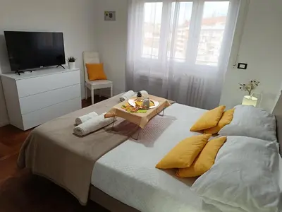 a bedroom with a large bed with a tv on it at Casa Vacanze Mafalda - Roma Stazione Trastevere in Rome