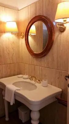 a bathroom with a sink and a mirror at Vatican Suites Happy Holidays in Rome
