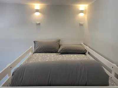 a bedroom with a bed with two pillows on it at A casa di Elly in Rome