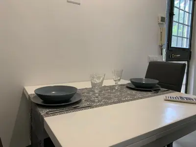 a table with two bowls and glasses on it at A casa di Elly in Rome