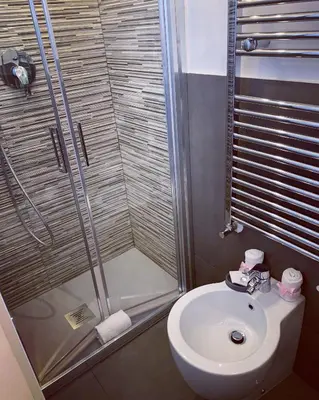 a bathroom with a shower and a toilet and a sink at A casa di Elly in Rome