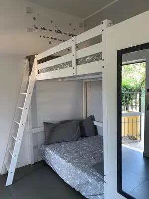 a bedroom with a bunk bed with a ladder at A casa di Elly in Rome