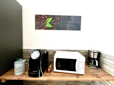a microwave sitting on top of a wooden shelf at I Pini di Roma - Rooms & Suites in Rome
