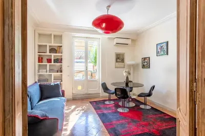 a living room with a blue couch and a table at Frattina Apartments in Rome