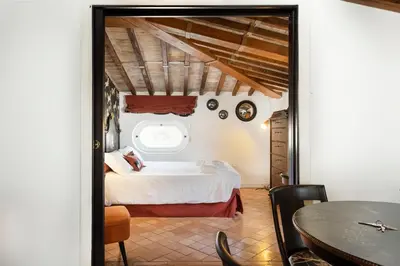 a bedroom with a bed and a table in a room at Frattina Apartments in Rome