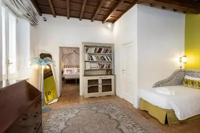 a bedroom with a bed and a book shelf at Gambero Apartments in Rome