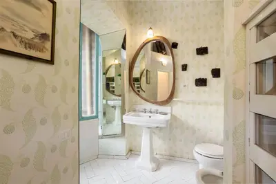 a bathroom with a sink and a mirror at Gambero Apartments in Rome