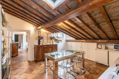 a kitchen with a glass table in a room at Gambero Apartments in Rome