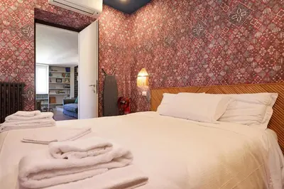 a bedroom with a bed with towels on it at Gambero Apartments in Rome