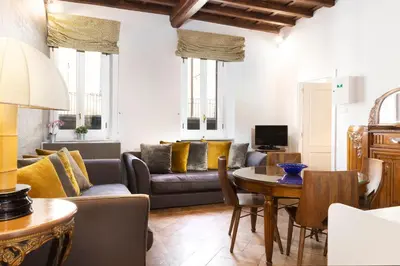 a living room with a couch and a table at Gambero Apartments in Rome