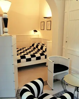 a room with two beds and a chair at Villa Laetitia in Rome