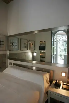 a bedroom with a white bed and a mirror at Villa Laetitia in Rome