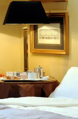 a tray of food on a table next to a bed at Hotel Villa Duse in Rome