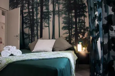 a bedroom with a bed with trees on the wall at giolitti central room in Rome