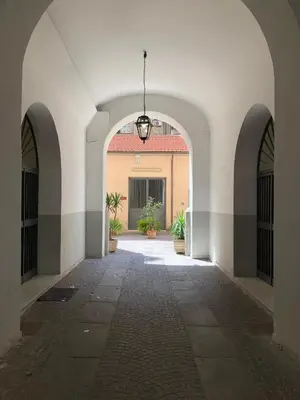 an alley way with arches and a building at giolitti central room in Rome