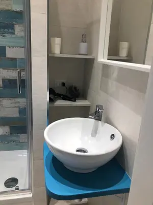 a bathroom with a white sink and a shower at giolitti central room in Rome