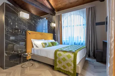 a hotel room with a bed and a large window at NEMAN Maison Experience I Pantheon in Rome