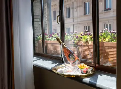 a bottle of wine sitting on a window sill with a bowl of food at NEMAN Maison Experience I Pantheon in Rome