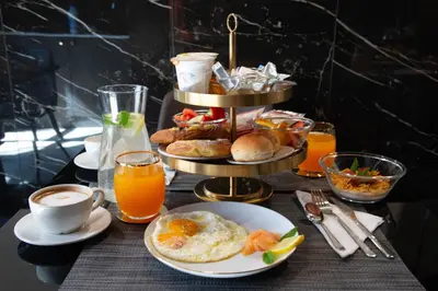 a breakfast table with a plate of food and orange juice at NEMAN Maison Experience I Pantheon in Rome