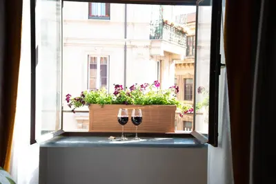 two glasses of wine sitting on a window sill at NEMAN Maison Experience I Pantheon in Rome