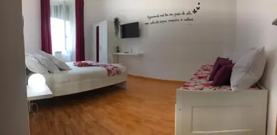 a bedroom with a bed and a tv on the wall at Orchids Apartment in Rome