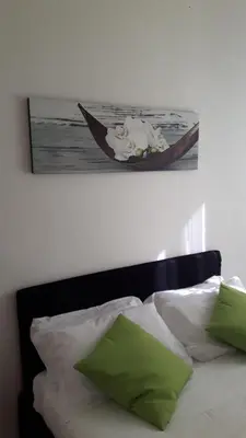 a picture of a man in a boat on a bed at Orchids Apartment in Rome
