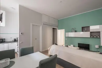 a room with a bed and a table and chairs at La Dimora del Cardinale in Rome