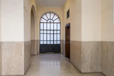 a hallway with a black door and a window at La Dimora del Cardinale in Rome