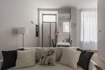 a white couch with pillows in a living room at La Dimora del Cardinale in Rome