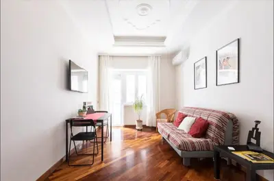 a living room with a couch and a table at Anton Inn Rome Cornelia Apartment in Rome