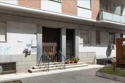 a building with a door and stairs in front of it at Anton Inn Rome Cornelia Apartment in Rome