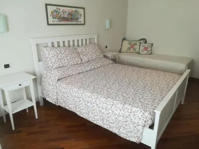a small bedroom with a bed and a night stand at Anton Inn Rome Cornelia Apartment in Rome