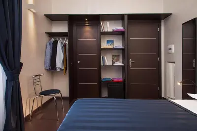 a bedroom with a bed and a closet at Residenza Dorò- 24x7 Check-in in Rome