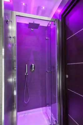 a purple shower with a glass door in a bathroom at Residenza Dorò- 24x7 Check-in in Rome