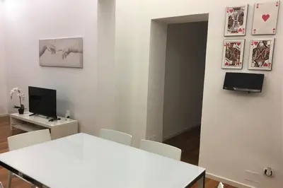 a white dining room with a table and chairs at Domus Caecilia - via Cola di Rienzo in Rome