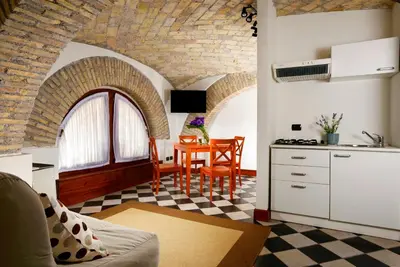 a kitchen and dining room with a table in a room at Roma Resort Termini in Rome