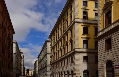 a yellow and white building on a city street at Roma Resort Termini in Rome