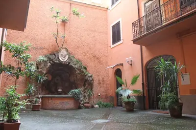 a courtyard with a fountain in a building at Colosseo Smart Flat in Rome