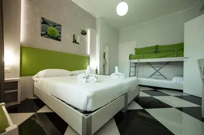 a bedroom with two bunk beds and a checkered floor at Star of Rome in Rome