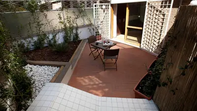 a small courtyard with a table and chairs on a patio at Star of Rome in Rome