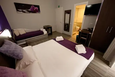 a hotel room with a bed and a mirror at Star of Rome in Rome