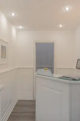 a white room with a counter and a window at Relais Roma Centro in Rome