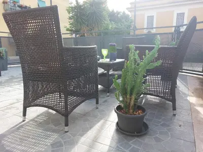 a patio with two chairs and a table with a cactus at Vic Pigneto, Luxury House Terrace Roma in Rome