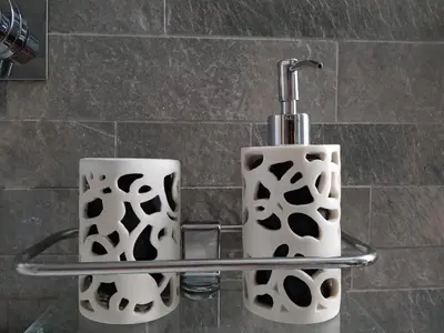 two cups sitting on a towel rack in a bathroom at Vic Colosseo, Centro Storico Roma in Rome
