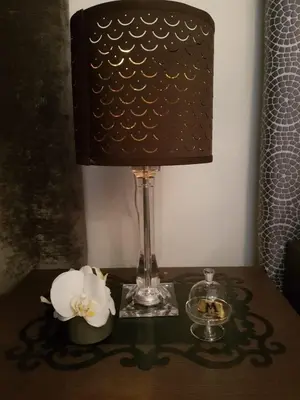 a table with a lamp and a white flower on it at Vic Colosseo, Centro Storico Roma in Rome